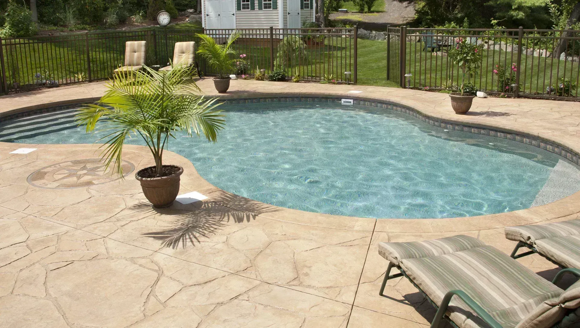 Textured coating surrounding a residential pool deck